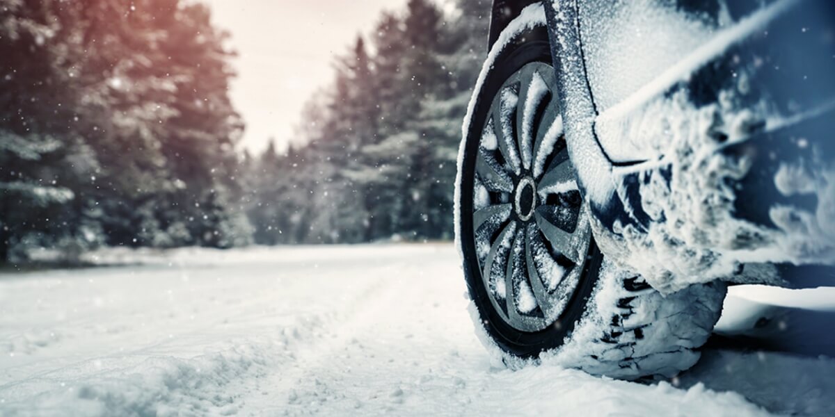 A vehicle with winter tires driving in snow